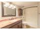 Well-lit bathroom featuring granite countertops and a shower with tub at 108 Mitchell Pl # 108, Daytona Beach, FL 32118