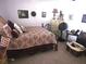 Comfortable bedroom with stylish wrought iron bed frame and neutral tones at 108 Mitchell Pl # 108, Daytona Beach, FL 32118