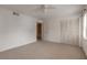 Bright bedroom featuring neutral carpet, ceiling fan, and a closet for ample storage at 108 Mitchell Pl # 108, Daytona Beach, FL 32118