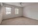 Cozy bedroom with two windows allowing natural light and carpeted flooring at 108 Mitchell Pl # 108, Daytona Beach, FL 32118