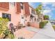 Charming townhome with peach exterior, red roof, and well-maintained landscaping at 108 Mitchell Pl # 108, Daytona Beach, FL 32118
