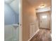 Hallway view with wood floors, a half bath, and stairs leading to the upper level at 108 Mitchell Pl # 108, Daytona Beach, FL 32118