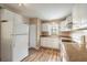 Functional kitchen with wood floors, white appliances, and ample counter space at 108 Mitchell Pl # 108, Daytona Beach, FL 32118