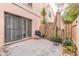 Private patio space featuring a grill, leafy plants, and a decorative umbrella for outdoor enjoyment at 108 Mitchell Pl # 108, Daytona Beach, FL 32118
