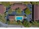 Aerial view showcasing the community pool, building, and parking lot at 112 Lacosta Ln # 115, Daytona Beach, FL 32114
