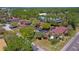 Aerial view of the community, showing the buildings, parking lots, and surrounding trees at 112 Lacosta Ln # 115, Daytona Beach, FL 32114