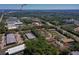 Aerial view showing the community with surrounding commercial areas and lush landscaping at 112 Lacosta Ln # 115, Daytona Beach, FL 32114
