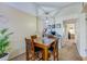 Cozy dining area with a square table, four chairs, and unique light fixture at 112 Lacosta Ln # 115, Daytona Beach, FL 32114