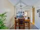 Cozy dining area with a square table, four chairs, and unique light fixture at 112 Lacosta Ln # 115, Daytona Beach, FL 32114