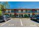 Condo exterior with parking spaces and second story units, perfect for convenient living at 112 Lacosta Ln # 115, Daytona Beach, FL 32114