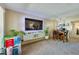 Open-concept living area with modern entertainment center and comfortable dining space at 112 Lacosta Ln # 115, Daytona Beach, FL 32114