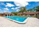 Inviting community pool area with comfortable lounge seating and lush landscaping at 112 Lacosta Ln # 115, Daytona Beach, FL 32114