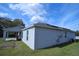 Back exterior view of home featuring a covered patio and solar panels on the roof at 1162 Prescott Blvd, Deltona, FL 32738