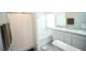 Bathroom featuring a shower with curtain, double sink vanity, and modern fixtures at 1162 Prescott Blvd, Deltona, FL 32738