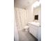 Well-lit bathroom with a patterned shower curtain, single vanity, and tiled floors at 1162 Prescott Blvd, Deltona, FL 32738