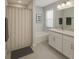 Neutral bathroom featuring shower, tub, white vanity, and modern fixtures at 1162 Prescott Blvd, Deltona, FL 32738