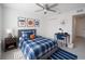 Bright bedroom featuring a ceiling fan, a closet, and desk with basketball decor at 1162 Prescott Blvd, Deltona, FL 32738