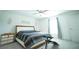 Bright bedroom featuring a ceiling fan, large window with curtains, and wood furniture at 1162 Prescott Blvd, Deltona, FL 32738