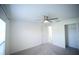 Carpeted bedroom with ceiling fan, large window and closet at 1162 Prescott Blvd, Deltona, FL 32738