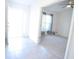 Bright entryway with tile flooring leading to a cozy living room with neutral carpet and a ceiling fan at 1162 Prescott Blvd, Deltona, FL 32738