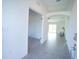 Open-concept entryway with tile flooring, arched accents, and access to a carpeted living area at 1162 Prescott Blvd, Deltona, FL 32738