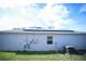 Back exterior view of house showing solar panels, stucco and AC unit at 1162 Prescott Blvd, Deltona, FL 32738