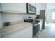 Kitchen with marble countertops, stainless steel appliances, and white cabinets at 1162 Prescott Blvd, Deltona, FL 32738