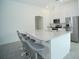 Modern kitchen island with marble countertops, stainless appliances, and seating at 1162 Prescott Blvd, Deltona, FL 32738