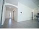 Open and inviting living room space with tile flooring, and a view of the entryway at 1162 Prescott Blvd, Deltona, FL 32738