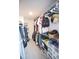 Walk-in closet equipped with metal shelves, hanging clothes, boxes, and clear plastic storage containers at 1162 Prescott Blvd, Deltona, FL 32738