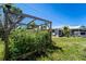 View of the backyard featuring lush greenery and a charming chicken coop, perfect for country living at 1199 Galgano Ave, Deltona, FL 32725