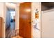 The open bathroom features a toilet, vanity, storage shelves, and a pink bathtub at 1199 Galgano Ave, Deltona, FL 32725
