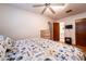 Comfortable bedroom featuring a ceiling fan, wood floors, and access to the ensuite bathroom at 1199 Galgano Ave, Deltona, FL 32725