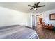 The bedroom features a hardwood floor, a ceiling fan, and an open doorway to another room at 1199 Galgano Ave, Deltona, FL 32725