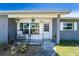 Inviting front porch with rocking chairs and decorative hanging plants for relaxation and curb appeal at 1199 Galgano Ave, Deltona, FL 32725