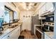 Charming kitchen with stainless steel appliances and granite countertops at 1199 Galgano Ave, Deltona, FL 32725