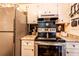 Kitchen featuring granite countertops, white cabinets and stainless appliances at 1199 Galgano Ave, Deltona, FL 32725