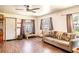 Comfortable living area with wood floors, natural light, and a cozy sofa at 1199 Galgano Ave, Deltona, FL 32725