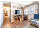 Cozy living room with wood floors, a decorative door, and a media console at 1199 Galgano Ave, Deltona, FL 32725