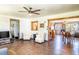 Open floor plan featuring living, dining, and kitchen areas, with wood-look flooring throughout at 1199 Galgano Ave, Deltona, FL 32725