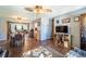 Open concept living and dining area featuring wood floors and vintage lighting fixtures at 1199 Galgano Ave, Deltona, FL 32725