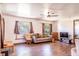 Spacious living room with wood floors, multiple windows, and comfortable seating arrangements at 1199 Galgano Ave, Deltona, FL 32725
