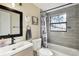 Bathroom with vanity, toilet, tub/shower with gray tile surround and decorative shower curtain at 1265 Aquarius Ave, Deland, FL 32724