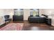 Bedroom with dark wood floors, two windows, a bed, and chair at 1265 Aquarius Ave, Deland, FL 32724