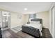 Bedroom featuring a tufted bed, dark wood floors, adjacent bathroom, and natural light at 1265 Aquarius Ave, Deland, FL 32724