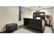 Bedroom with dark wood floors, a large bed, and a leather ottoman at 1265 Aquarius Ave, Deland, FL 32724