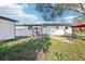 Charming single-Gathering home featuring a well-maintained lawn and a cozy outdoor seating area at 1265 Aquarius Ave, Deland, FL 32724