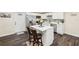 Modern kitchen featuring white cabinetry, stainless steel appliances, and a central island at 1265 Aquarius Ave, Deland, FL 32724