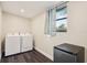 Bright laundry room includes washer, dryer, and a new stainless steel mini fridge at 1265 Aquarius Ave, Deland, FL 32724