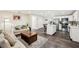 Open-concept living space with a modern kitchen, sleek flooring, and cozy seating area at 1265 Aquarius Ave, Deland, FL 32724
